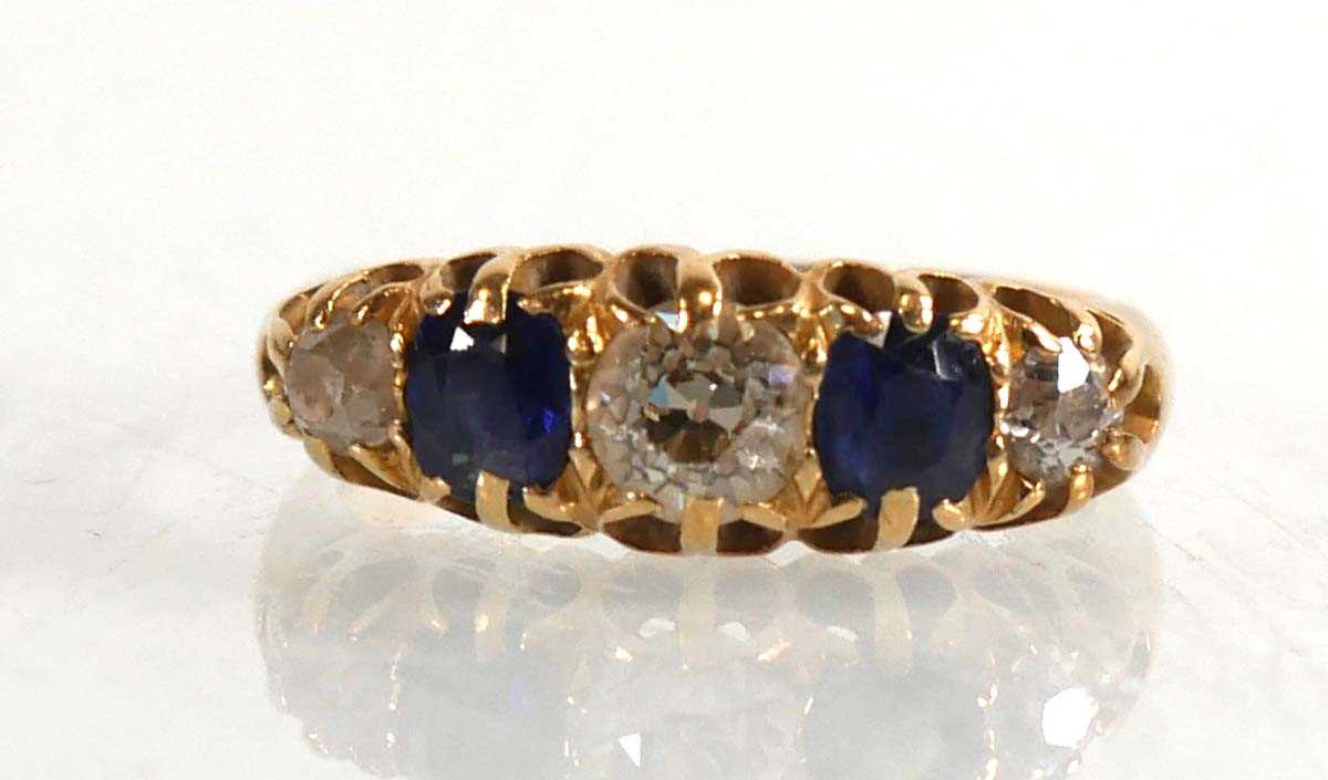 Lot 720 - An Edwardian 18ct yellow gold ring set three...