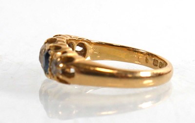 Lot 720 - An Edwardian 18ct yellow gold ring set three...