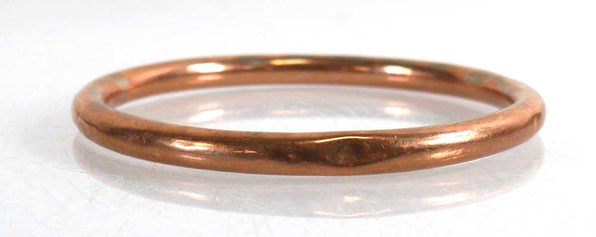 Lot 726 - A 9ct rose gold hollow slave bangle, internal...