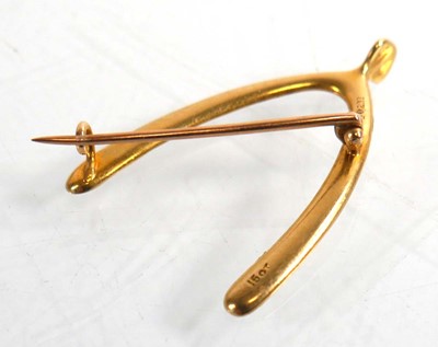 Lot 731 - A 15ct yellow gold brooch of wishbone form set...