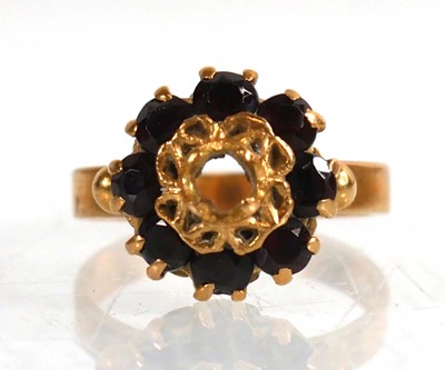 Lot 739 - An 18ct yellow gold cluster ring set garnet,...