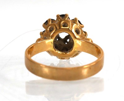 Lot 739 - An 18ct yellow gold cluster ring set garnet,...