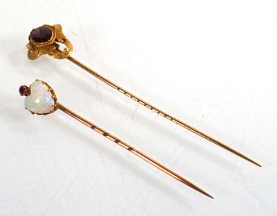 Lot 760 - A yellow metal stick pin set heart shaped opal...