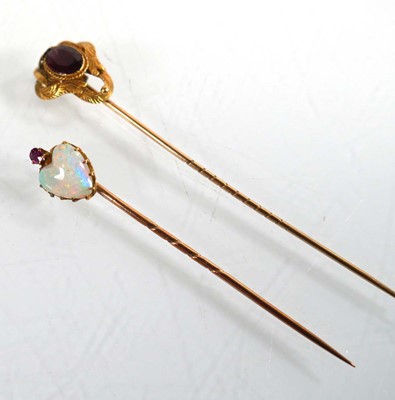 Lot 760 - A yellow metal stick pin set heart shaped opal...