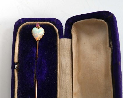 Lot 760 - A yellow metal stick pin set heart shaped opal...