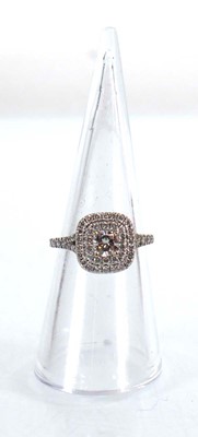 Lot 763 - An 18ct white gold halo ring set centrally...