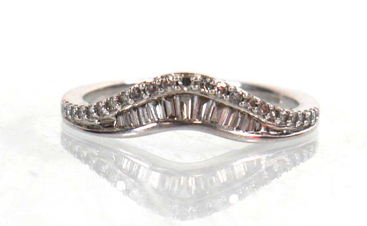 Lot 764 - A 9ct white gold half eternity ring set...