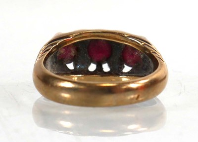 Lot 765 - A 9ct yellow gold ring set three garnets in a...