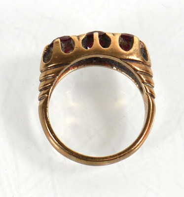 Lot 765 - A 9ct yellow gold ring set three garnets in a...