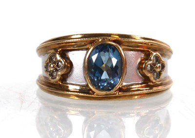 Lot 768 - A 9ct two colour gold ring set oval pale blue...