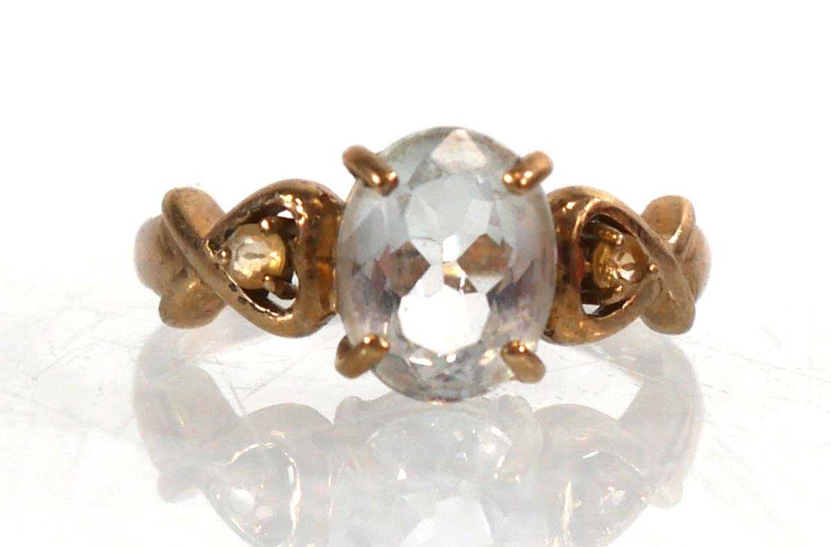 Lot 769 - A 9ct yellow gold ring set pale blue stone and...