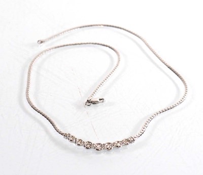 Lot 787 - A 9ct white gold flat curblink necklace set...