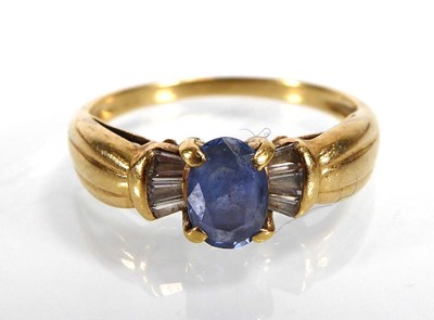 Lot 807 - An 18ct yellow gold ring set pale oval...