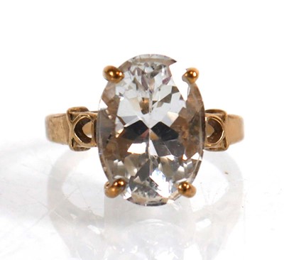 Lot 823 - A 9ct yellow gold ring set oval white stone...