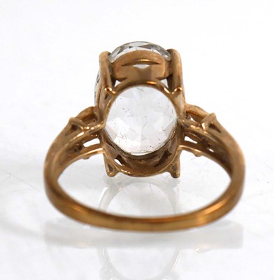 Lot 823 - A 9ct yellow gold ring set oval white stone...