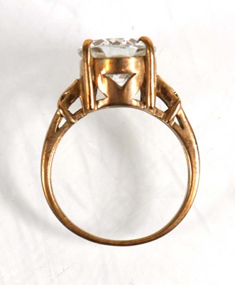 Lot 823 - A 9ct yellow gold ring set oval white stone...