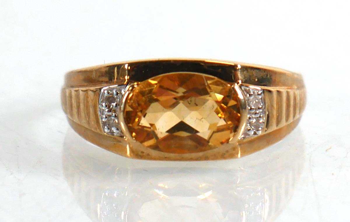 Lot 824 - A 9ct yellow gold ring set oval yellow stone...