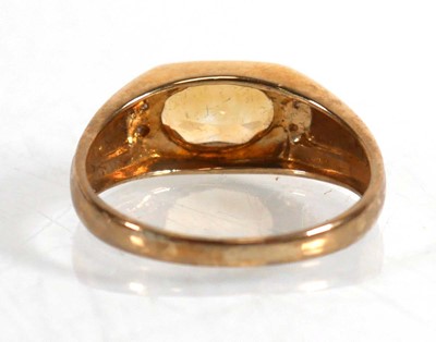 Lot 824 - A 9ct yellow gold ring set oval yellow stone...