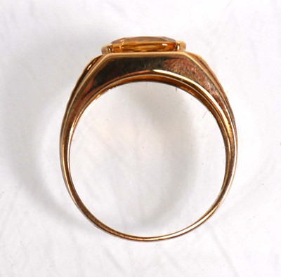 Lot 824 - A 9ct yellow gold ring set oval yellow stone...