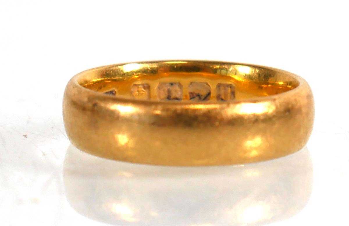 Lot 835 - A 22ct yellow gold wedding band, Birmingham...