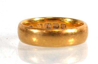 Lot 835 - A 22ct yellow gold wedding band, Birmingham...