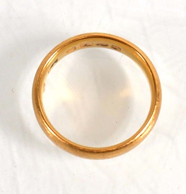 Lot 835 - A 22ct yellow gold wedding band, Birmingham...