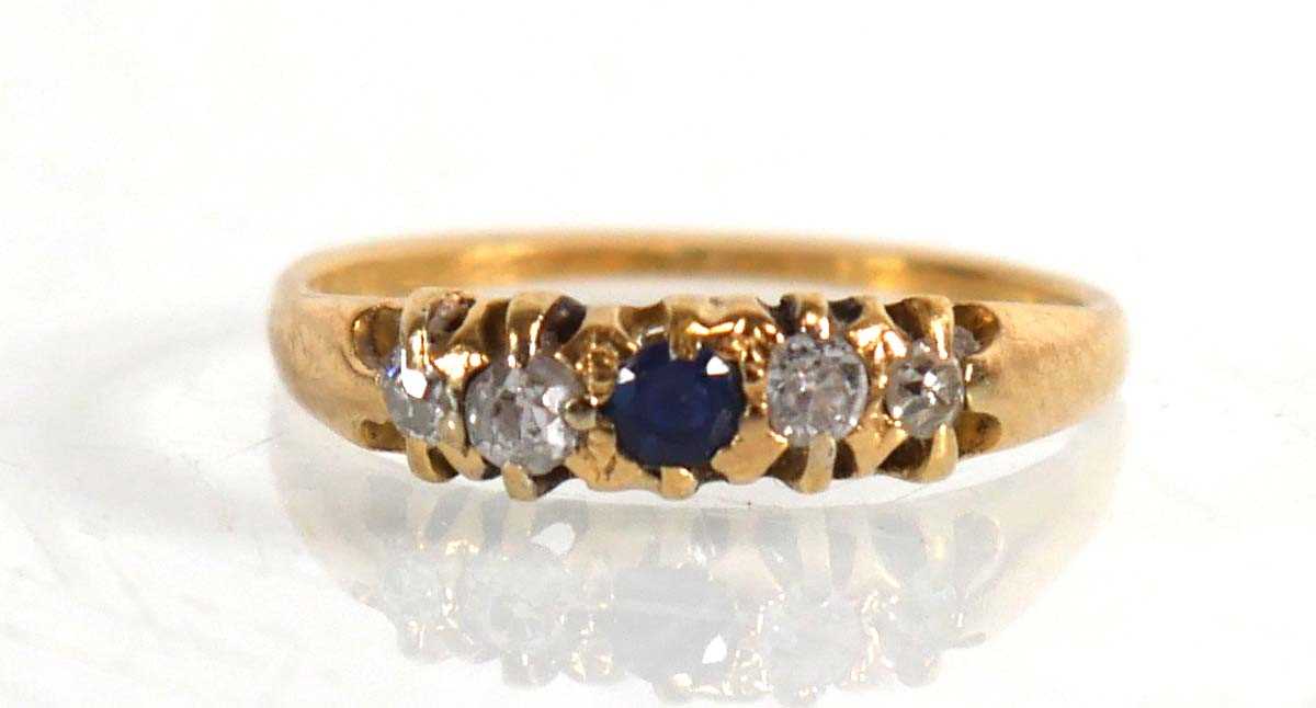 Lot 837 - An 18ct yellow gold ring set sapphire and four...