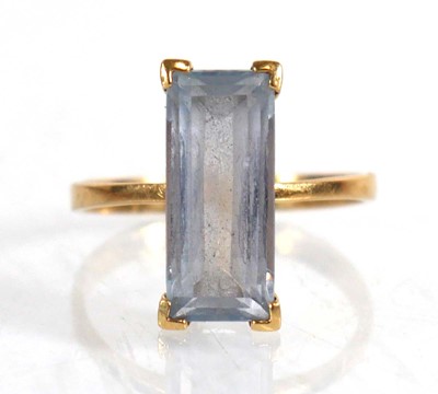 Lot 839 - A yellow metal ring set baguette cut pale blue...