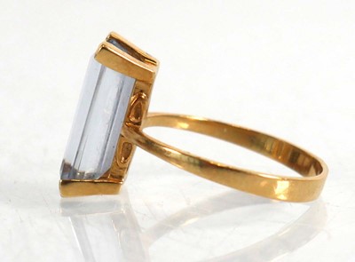 Lot 839 - A yellow metal ring set baguette cut pale blue...