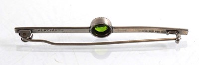 Lot 842 - A platinum bar brooch set green stone in a...