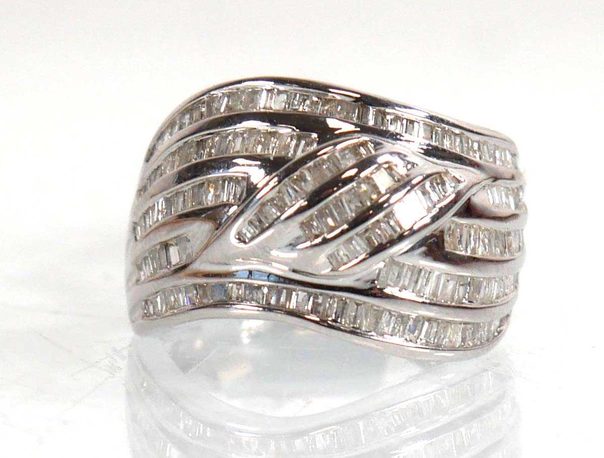 Lot 852 - A 9ct white gold band ring set small baguette...