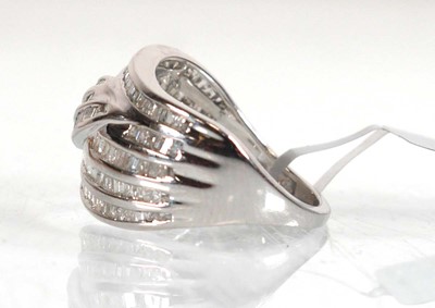 Lot 852 - A 9ct white gold band ring set small baguette...