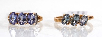 Lot 856 - A 9ct yellow gold ring set three oval...