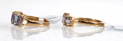 Lot 856 - A 9ct yellow gold ring set three oval...