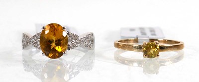 Lot 857 - A 9ct white gold ring set oval yellow stone...