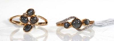 Lot 858 - Two 9ct yellow gold rings, each set grey...