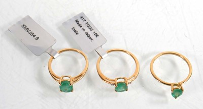 Lot 859 - Three 9ct yellow gold rings, each set oval...