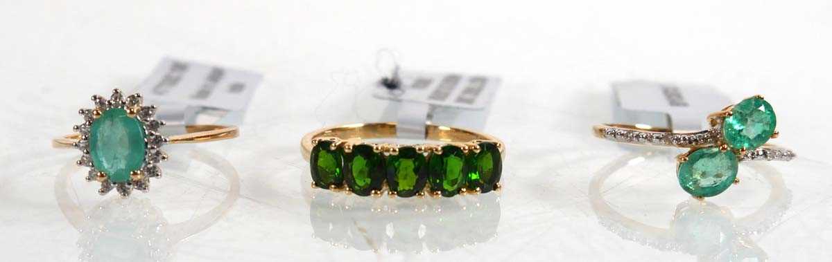 Lot 861 - Three 9ct yellow gold rings, each set emeralds...