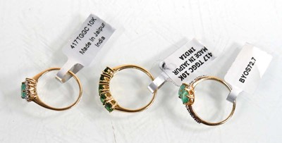 Lot 861 - Three 9ct yellow gold rings, each set emeralds...