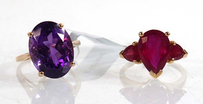 Lot 862 - A 9ct yellow gold ring set oval purple stone,...