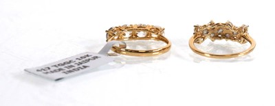 Lot 864 - A 9ct yellow gold ring set two rows of eleven...