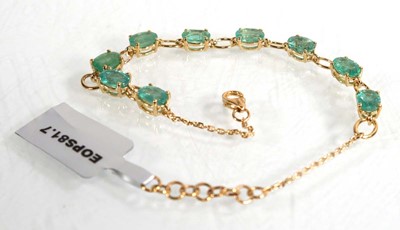 Lot 869 - A 9ct yellow gold bracelet set nine oval...