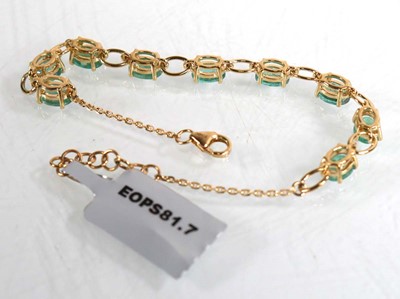 Lot 869 - A 9ct yellow gold bracelet set nine oval...