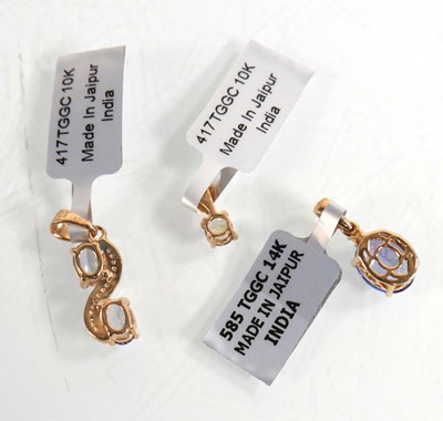 Lot 873 - Three 9ct yellow gold pendants, each set pale...