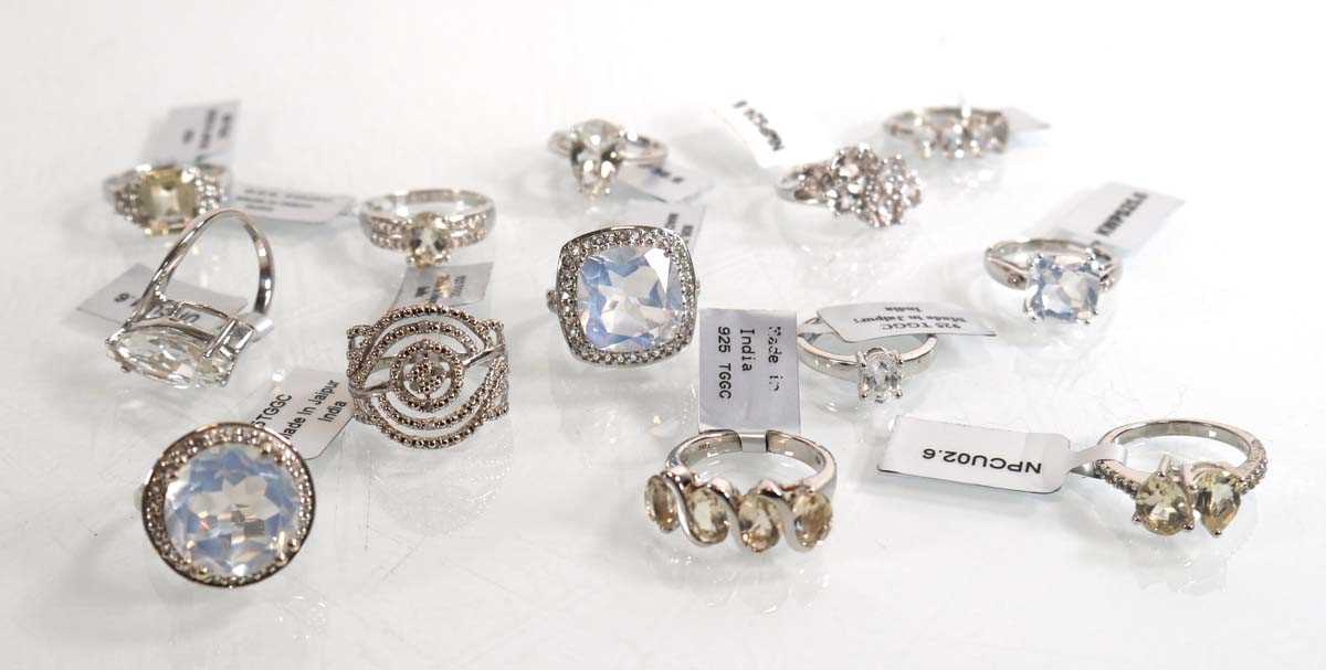 Lot 894 - Thirteen modern silver rings, each set white...