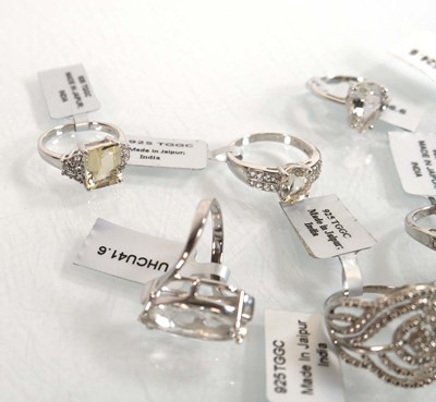 Lot 894 - Thirteen modern silver rings, each set white...