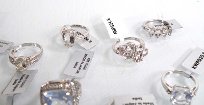 Lot 894 - Thirteen modern silver rings, each set white...