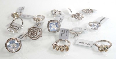 Lot 894 - Thirteen modern silver rings, each set white...