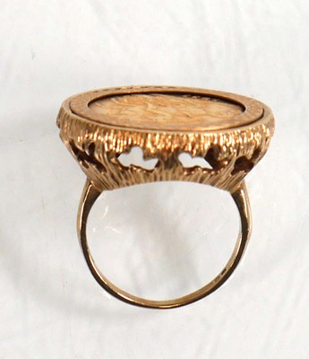 Lot 991 - A 9ct yellow gold ring set half sovereign...