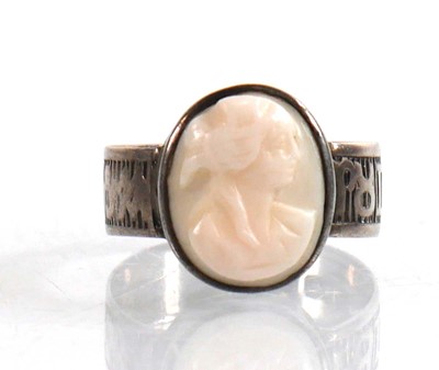 Lot 908 - A silver cameo ring, the band decorated with...